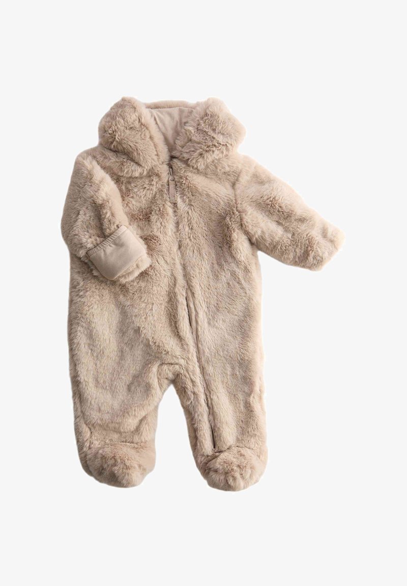 Fleece baby onesie in light beige, featuring a zip front, a hood, and booties. Soft texture with fluffy exterior and cuffed sleeves.