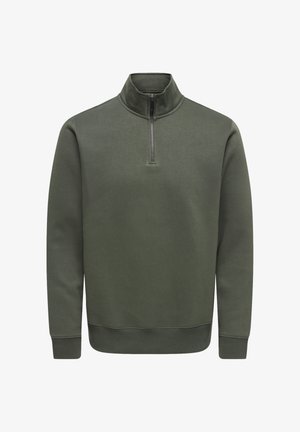 Pull-over à manches longues de couleur vert olive avec une demi-fermeture éclair à l'avant et des poignets et ourlet côtelés.
