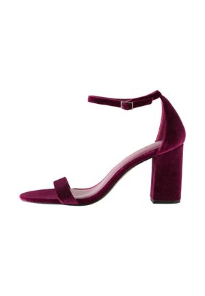 Velvet burgundy heeled sandal with a thin toe strap and ankle strap, featuring a block heel and smooth inner lining.