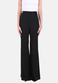 Pantaloni neri a gamba larga con una trama liscia, vita alta e pieghe frontali. Il tessuto è leggero e modellato per una vestibilità strutturata.