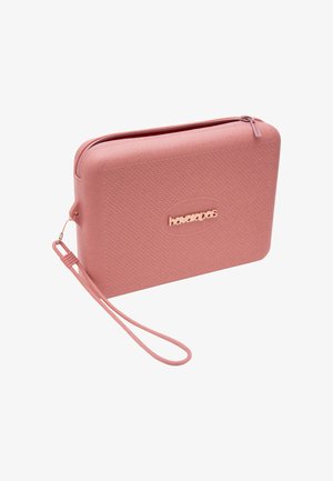 Portamonete rettangolare rosa con texture, chiusura con cerniera e logo "havaianas" sul davanti, con cinturino abbinato.