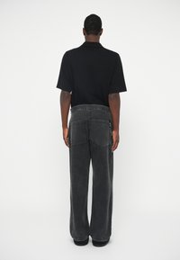 Aries UNISEX - Calças de ganga largas - black