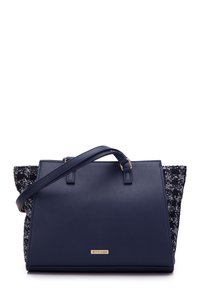 Navy blue handbag with a smooth leather front and a textured tweed back, featuring dual handles and a detachable shoulder strap. Gold logo detail.