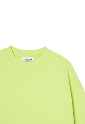 Sudadera de gran tamaño color verde claro de Lacoste con cuello redondo y logo de cocodrilo bordado en tono a la izquierda del pecho.