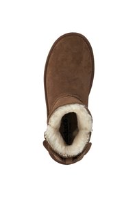 Brown suede boot with a soft cream fur lining, rounded toe, and stitched accents along the edges. Includes a side pull tab for easy wear.