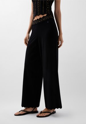STUDSSTRASS - Trousers - black