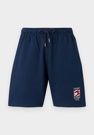 Short bleu marine à taille élastique avec cordon de serrage et logo Tommy Hilfiger avec un motif de drapeau rouge, blanc et bleu sur la jambe avant.