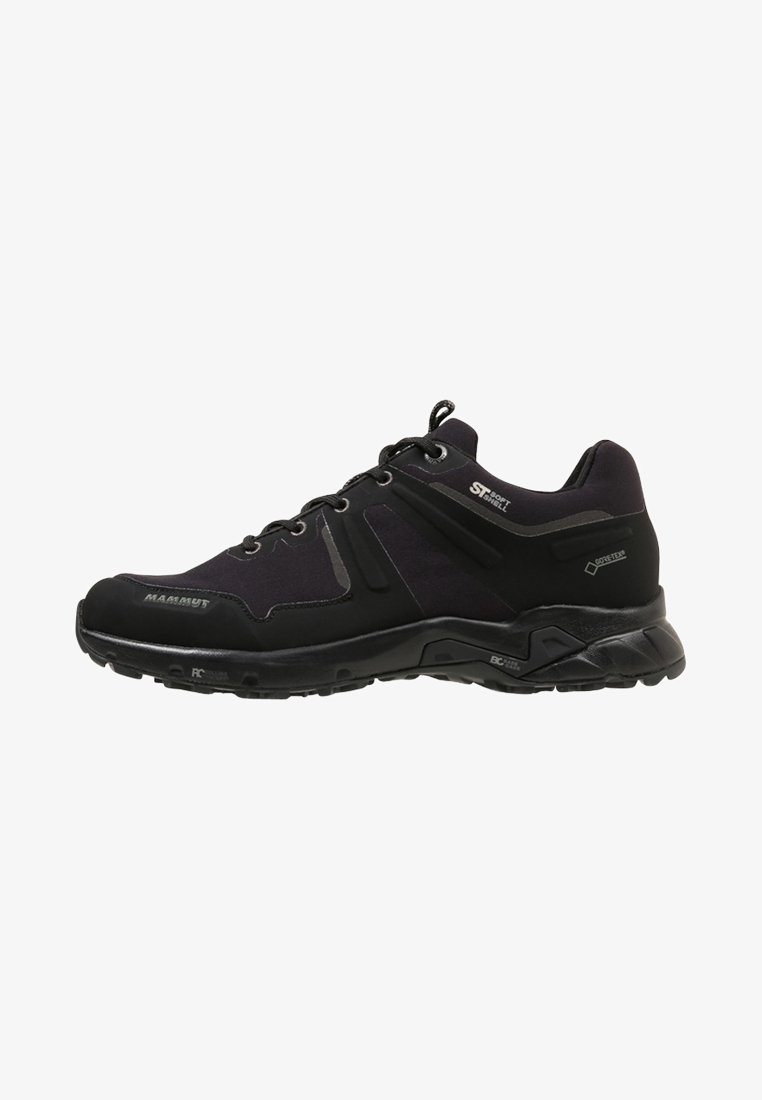 Black low-cut hiking shoe with lace-up closure, textured sole, and branding including Mammut, Soft Shell, and Gore-Tex logos visible.