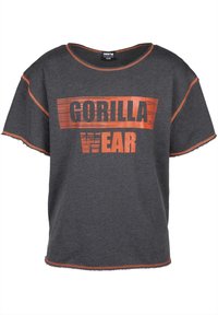 Grijze T-shirt met korte mouwen met opvallende oranje tekst "GORILLA WEAR". Versleten zoom en oranje stiksel. Comfortabele pasvorm.