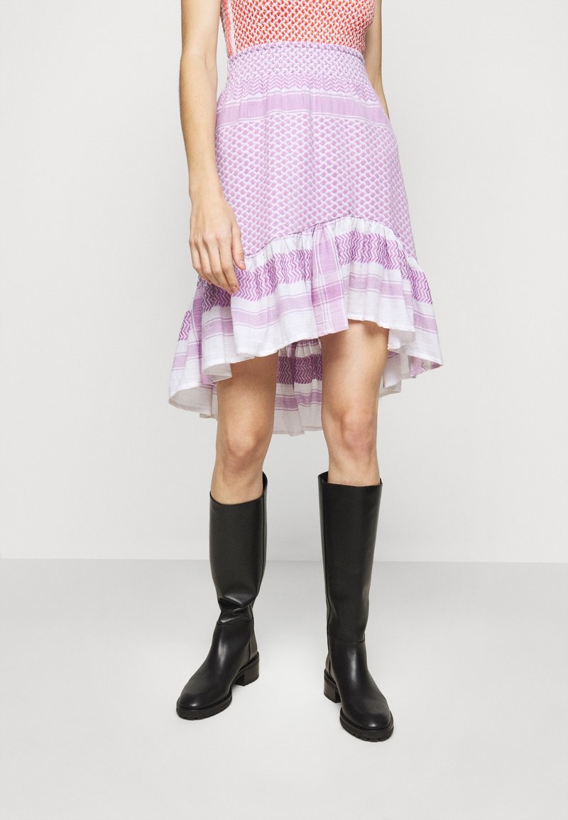 Purple patterned skirt with a ruffled hem, worn with knee-high black boots. The skirt has multiple fabric textures and a fitted waist.