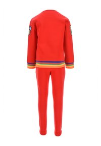 Red two-piece tracksuit made of soft material, featuring long sleeves, ribbed cuffs, and a colorful striped hem and accents.