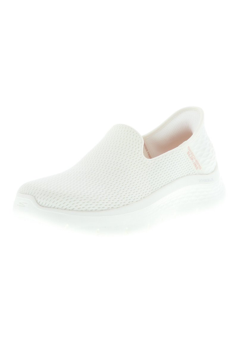 Zapatos blancos sin cordones con parte superior de malla, superficie texturizada y forro suave. Cuenta con una suela de goma con un ligero acolchado y un branding minimalista.