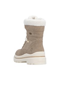 Wasserabweisender beiger Stiefel mit Kunstfellbund, gepolstertem Kragen und weißer Gummisohle. Verfügt über ein Schnürdesign und ein Logo an der Seite.