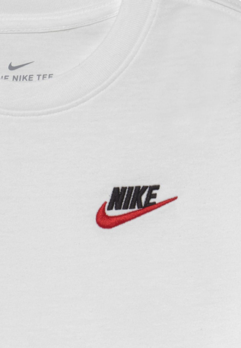 white nike shirt with red logo
