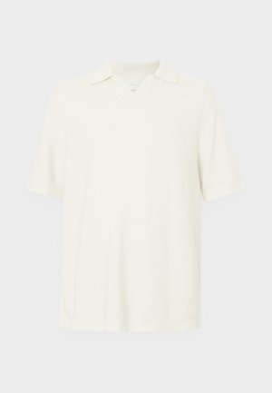 Kurzärmeliges Poloshirt in hellecreme Farbe, aus strukturiertem Stoff, mit V-Ausschnitt und klassischem Kragen.