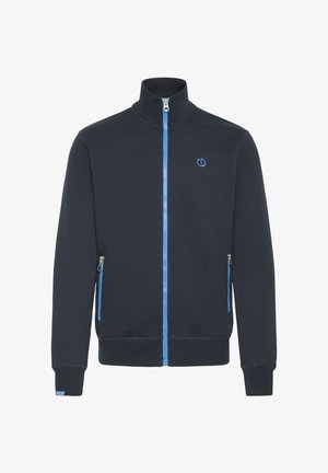 Tumma laivastonsininen vetoketjullinen takki pehmeästä puuvillasekoitteesta, jossa on korkea kaulus, kontrastina vaaleansininen vetoketju ja yksityiskohdat sekä sivutaskut.