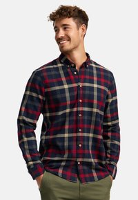 Kariertes Flanellhemd in Marineblau, Rot und Beige, mit Button-Down-Kragen, langen Ärmeln und Holzknöpfen. Weicher Stoff.