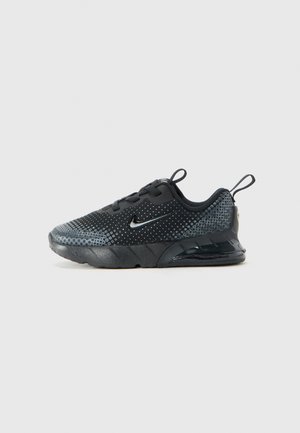Sort Nike træningssko med grå prikmønster, synlig luftcushion sål og trækflapper på tunge og hæl, vist i sideprofil.