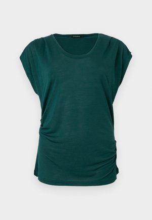 Teal t-skjorte med kort erme, rund hals, detaljer med samling på siden og løs passform. Laget av lett, myk stoff.