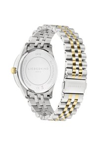 Montre en acier inoxydable avec un bracelet bicolore argent et or, un boîtier rond, un fond transparent et une couronne avec un accent doré.