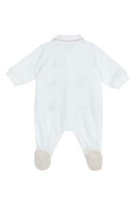 Un body en coton blanc pour bébé avec des manches longues, un col et des accents rayés sur les grips des pieds. Texture douce avec un design simple.