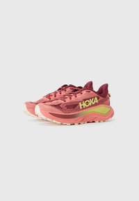 Pink and burgundy running shoes with breathable mesh upper, cushioned sole, and bold yellow brand logo. Treaded outsole for traction.