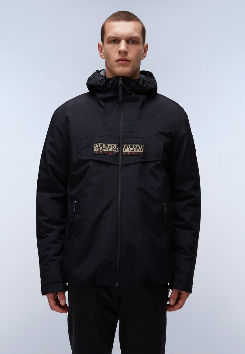 Schwarze Kapuzenjacke mit einem Frontreißverschluss, ausgestattet mit einem kontrastierenden Logo-Patch und Seitentaschen, gefertigt aus einem matten, leichten Material.