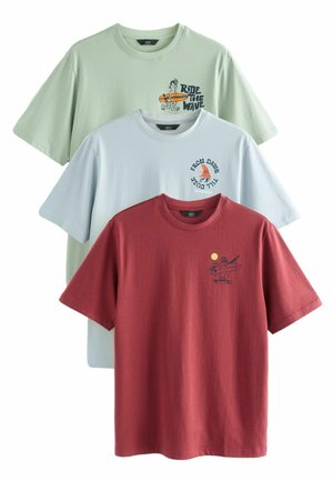 Three cotton t-shirts in light green, light blue, and burgundy. Each features unique graphics: surfer, text, and sun accents. Short sleeves.