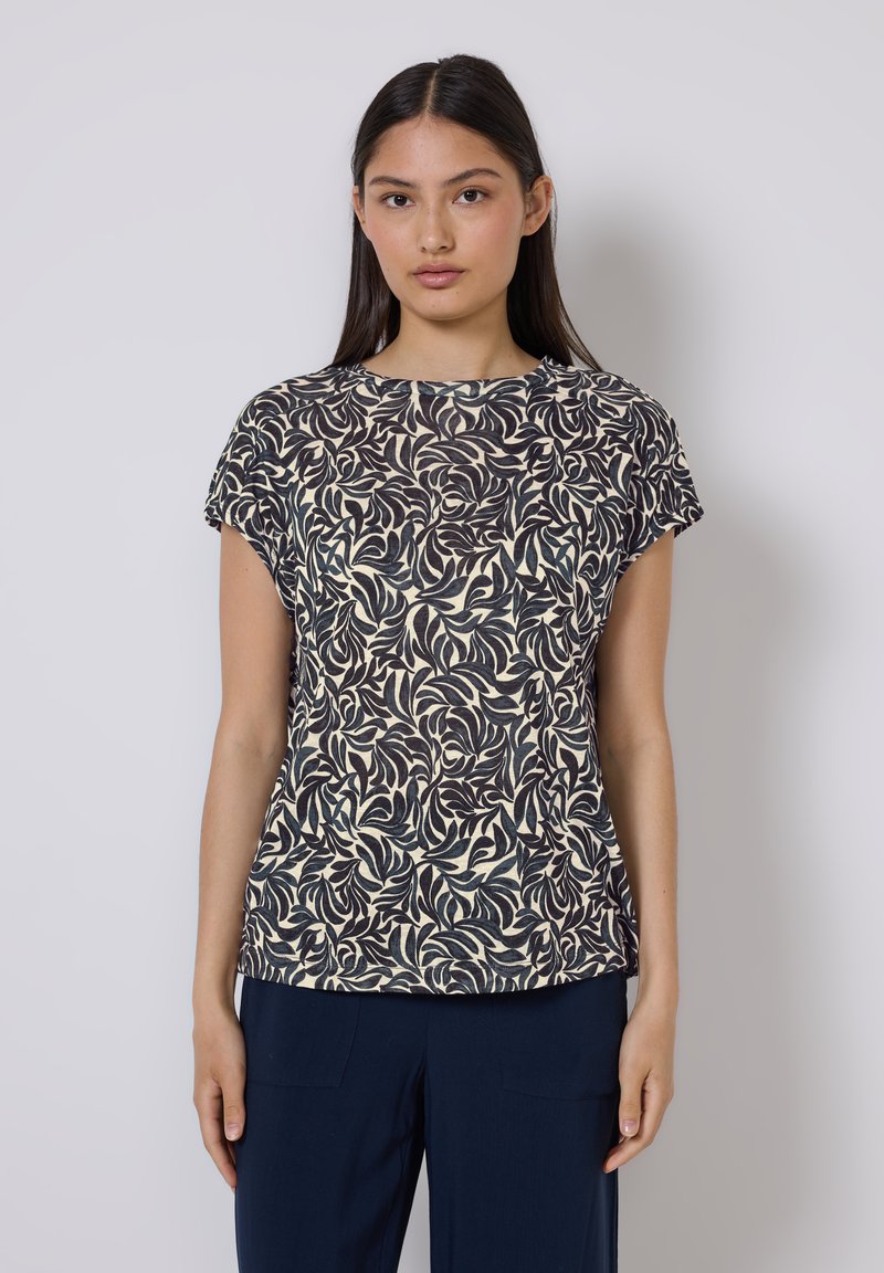 Kurzärmlige Bluse mit Rundhalsausschnitt in Creme mit dunklem, floralem Blattmuster, aus leichtem, strukturiertem Stoff gefertigt. Gerader Schnitt.