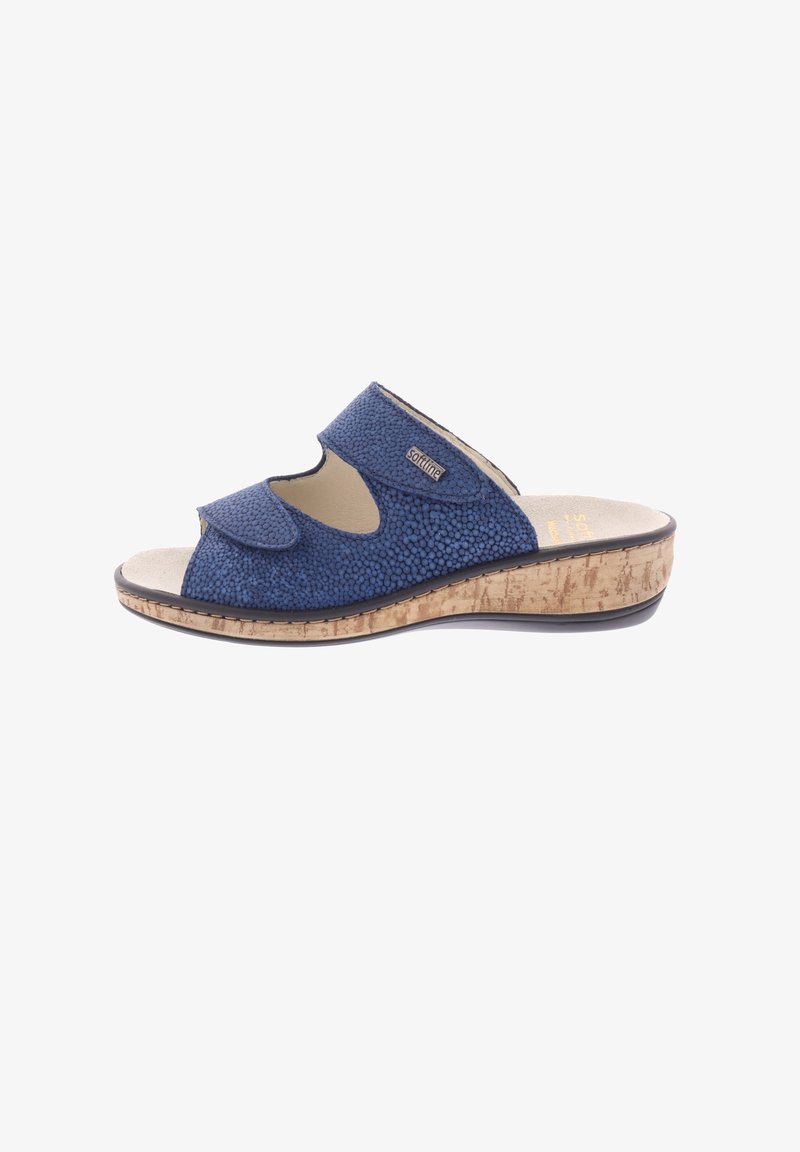 Blue slip-on sandal with textured upper, open toe, two adjustable straps, and a cork-like wedge sole. Features logo detail on the side.