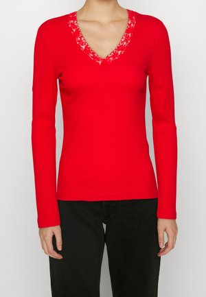 Rotes geripptes Langarmoberteil mit V-Ausschnitt, verziert mit floralem Spitzenbesatz. Enganliegendes Design, glatte Textur und sanfter Stretch für zusätzlichen Komfort.