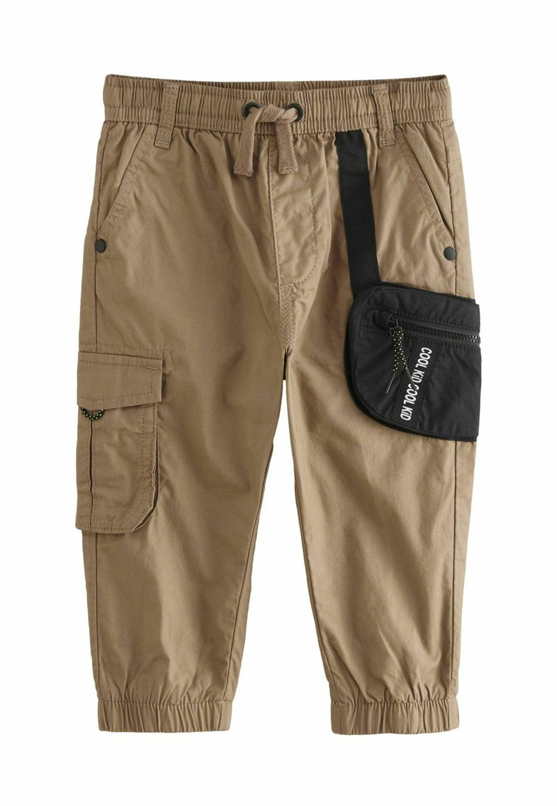Beige Cargo-Hosen mit elastischem Bund und Kordelzug. Mit Seitentaschen und einem schwarzen Reißverschlussbeutel mit Aufschrift. Elastische Bündchen an den Knöcheln.