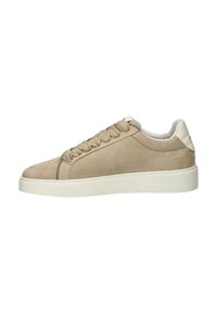 Beige suede sneaker with round toe, thick white rubber sole, and braided laces. Features soft leather back detail and stitching accents.