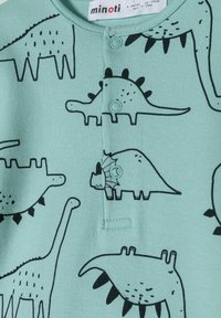 Mentol zelena kombinacija s crnim ilustracijama dinosaura. Dizajn uključuje dugmad sprijeda i različite oblike i veličine dinosaura.