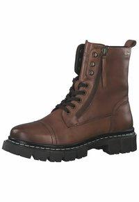 Bottines en cuir marron avec des lacets à l'avant et une fermeture éclair sur le côté. Elles disposent d'une semelle épaisse noire avec des coutures blanches et des œillets en métal.