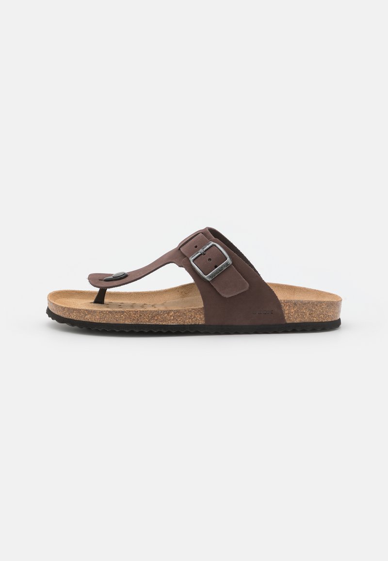 Rudos suede šlepetės flip-flop tipo su piršto postu, reguliuojama juosta su sidabriniu sagtimi, kamštinės pado ir tekstūruotu juodu guminiu padu.