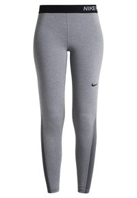 Leggings sportivi grigi con una vita nera e un logo Nike discreto. Presentano un design aderente e pannelli accentuati di un grigio scuro a contrasto.