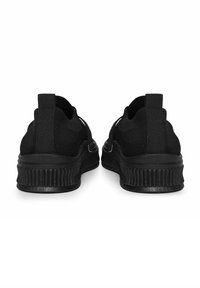 Sorte strikkede sneakers med et mønstret design, der har forhøjelser og en tyk, rillet gummisål for bedre greb.