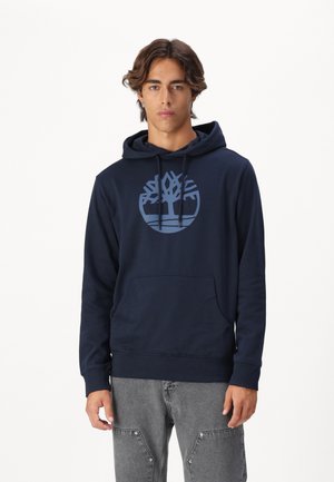 Navy blue hooded sweatshirt, soft fabric, featuring a large light blue tree logo on the chest, kangaroo pocket, and ribbed cuffs and hem.