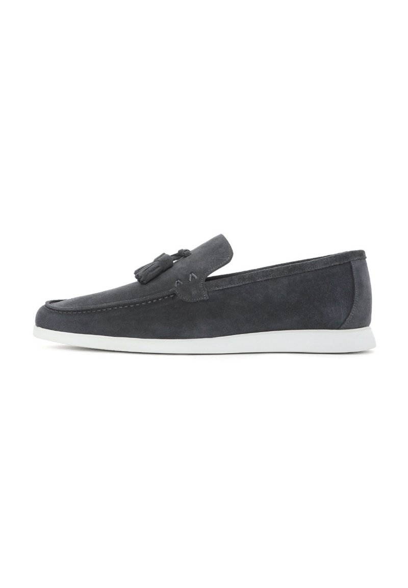 Dark blue suede loafers with tassel detail, white rubber sole, rounded toe, and stitching accents on the upper. Simple and sleek design.