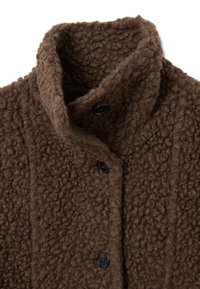Manteau en polaire marron texturé avec un col haut, doté de deux boutons noirs et de détails de couture verticale. Matière douce et confortable.