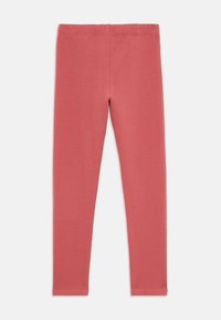 Rote Stretch-Leggings aus weicher Baumwolle, mit einem nahtlosen Bund und einer schmalen Passform, geeignet für Freizeit- oder Sportbekleidung.