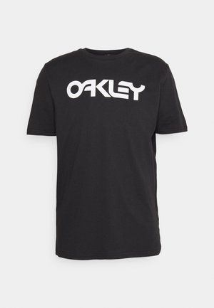 Czarna bawełniana koszulka z krótkim rękawem z dużym białym logo "OAKLEY" nadrukowanym na piersi. Okrągły dekolt, standardowy krój.