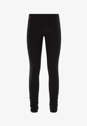 Schwarze Leggings aus dehnbarem Material, mit hohem Taillenbund und gerafften Akzenten an den Knöcheln. Insgesamt glatte Textur.