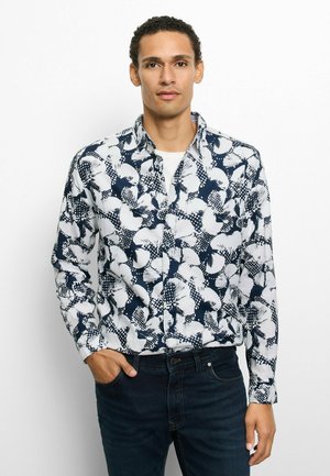 Langärmliges Hemd mit Knöpfen in Marineblau und Weiß mit einem Muster aus abstrakten Formen und Punkten. Aus Baumwolle gefertigt, mit klassischem Kragen und regulärer Passform.