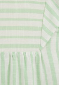 Light fabric with alternating green and white striped pattern, featuring a gathered detail at the hem and a folded section at the top.