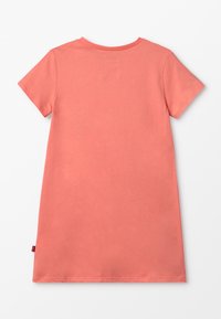 Koronkowa sukienka t-shrt z krótkim rękawem w kolorze koralowym, z okrągłym dekoltem, gładkim materiałem bawełnianym i małą naszywką na plecach, charakteryzująca się luźnym krojem.