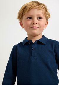 Navy blue long-sleeve polo shirt featuring a collar, two-button placket, and textured fabric. Offers a relaxed fit and stitched accents.