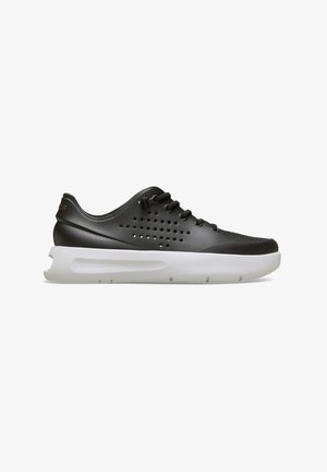 Czarny niskoprofilowy sneaker z perforowanymi bokami, czarnymi sznurowadłami i grubą białą podeszwą, prezentowany na białym tle.