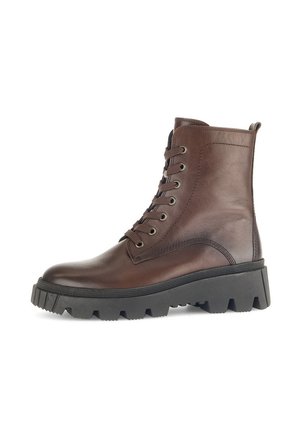 Bottines en cuir marron avec un bout arrondi, semelle en caoutchouc noir épais et six œillets pour les lacets. Comprend une languette à l'arrière pour un enfilage facile.